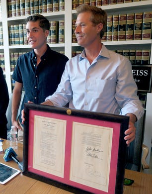 On the 5th Anniversary of its signing, David Goldman is joined by his son Sean as he holds a copy of the Sean and David Goldman International Child Abduction Prevention and Return Act during a news conference in Red Bank Thursday, August 8, 2019.