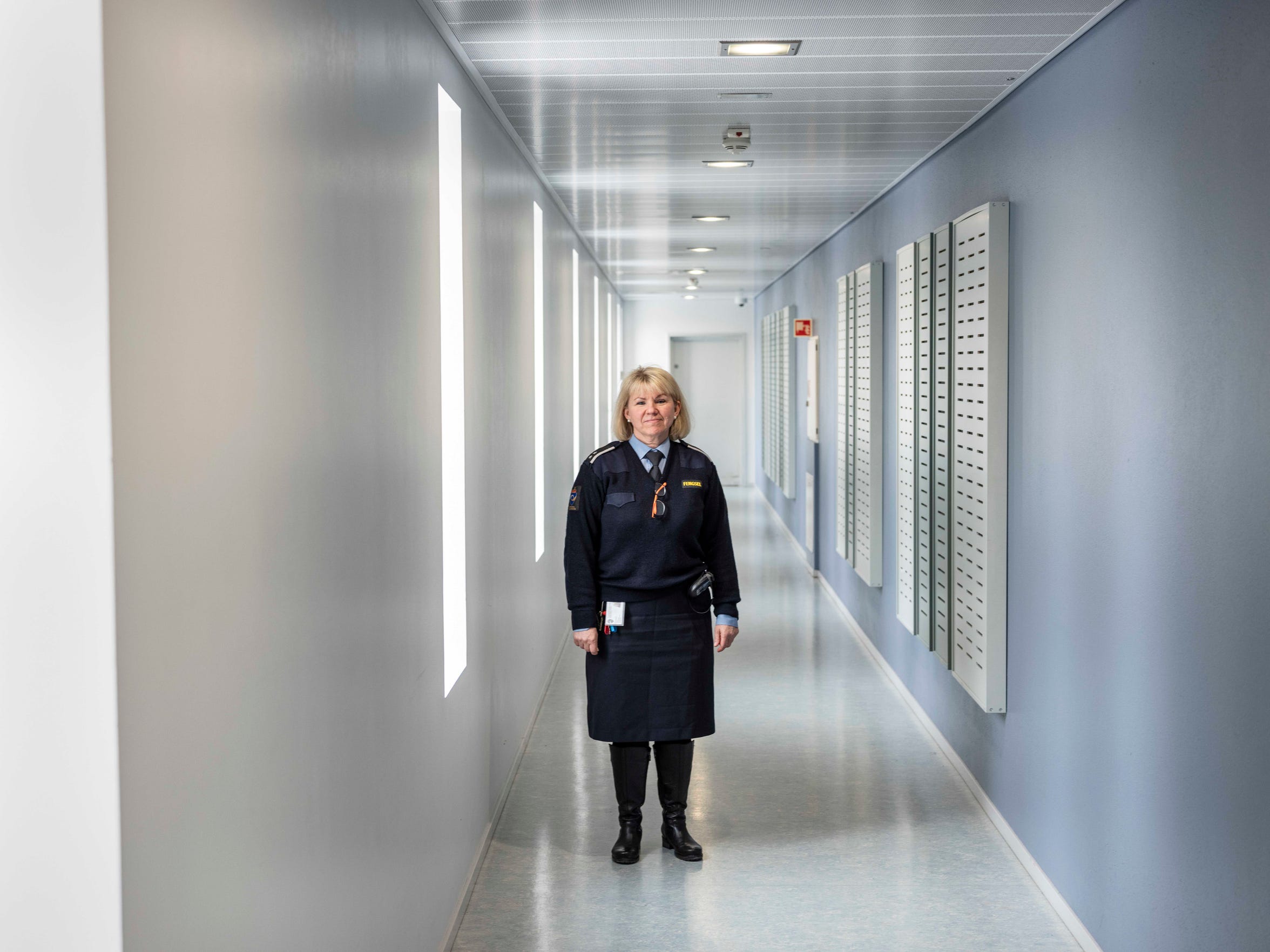 Works manager Janne Hasle stands in a light-filled corridor at Halden Prison in Norway, where inmates live in dorm-like rooms in three buildings on a campus filled with trees. 