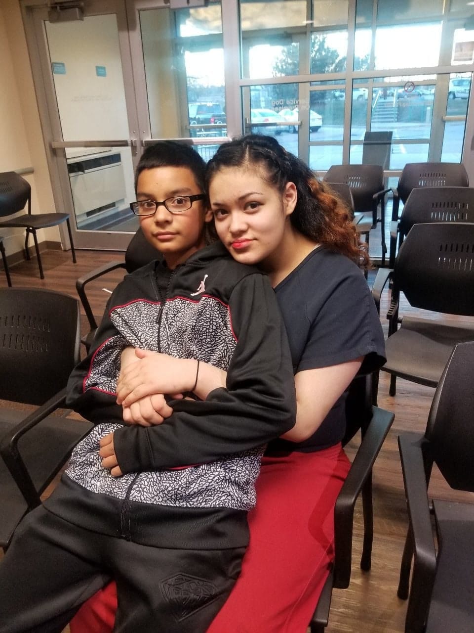 Maricella Chairez, 16, wraps her arms around her brother in the last picture they took together Dec. 8, 2017. They're at the Racine County Detention Center, where she died by suicide two days later.