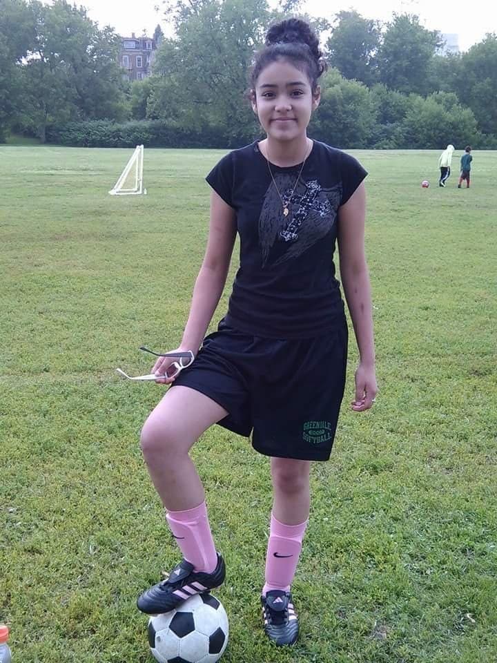 Maricella Chairez, at age 12, poses with a soccer ball.