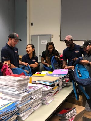Volunteers from The United Way of Ventura County are stuffing backpacks for their 2019 Stuff the Bus project.