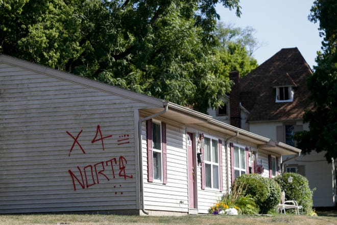 Graffiti appears on a building on 13th st, Friday, Aug. 9, 2019 in Lafayette. 