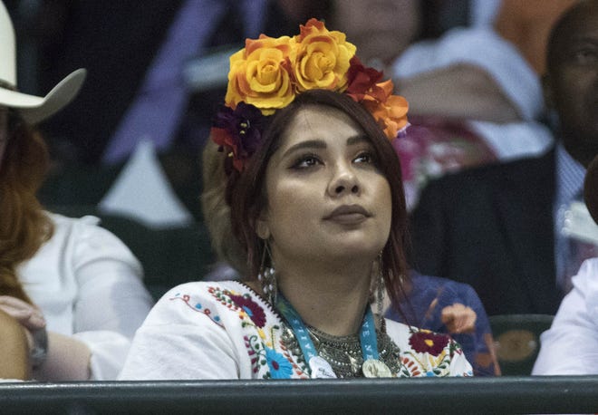 A Jehovah's Witnesses enthusiast watches a guest speaker during the  2019 Convention of Jehovah's Witnesses at Chase Field in Phoenix on Aug. 9, 2019.