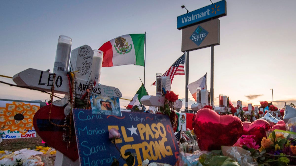 People pray and pay their respects at the makeshift memorial for victims of the shooting that left a total of 22 people dead at the Cielo Vista Mall Walmart in El Paso, Texas,