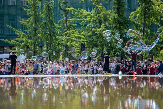 Protesters hold signs and make soap bubles during a 'Fridays for Future' demonstration near the Federal Ministry of Economy in Berlin, Germany on August 9, 2019.