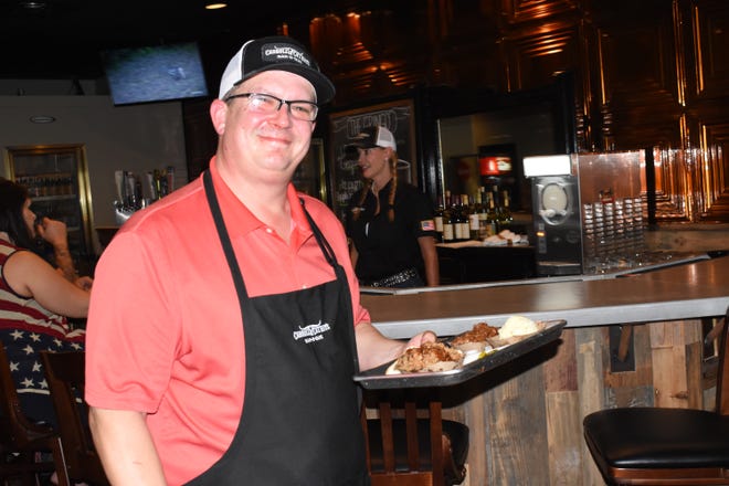 Carroll Cathey, owner of Carroll Cathey's Bar-B-Que, serves a pulled pork plate to a customer. The restaurant is located at 5803 Coliseum Blvd. where Beef O'Brady's restaurant was once located will open to the public Tuesday, Aug. 13, 2019. The hours for Carroll Cathey's Bar-B-Que will be: 11 a.m. to 9 p.m. Tuesday, Wednesday and Thursday; 11 a.m. until on Friday and Saturday and from 11 a.m. to 3 p.m. on Sunday. The establishment will be closed on Monday.