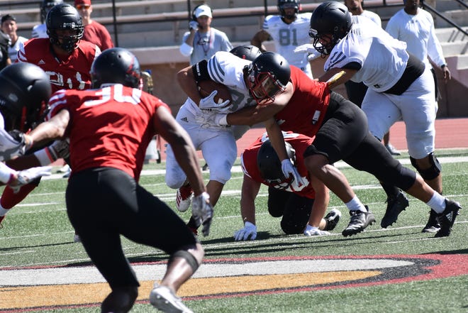 Defensive players fly to the ball carrier during one of SUU's fall camp scrimmages.