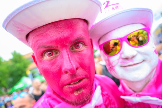 Two persons pose as they attend the 28th Street Parade, an annual dance music parade, in the city center and around the lake of Zurich, Switzerland, Saturday, Aug. 10, 2019. 