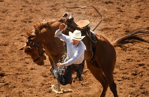 James Sclander comes off his horse in the saddle bronc event at the Mount Isa Mines Rodeo in Mount Isa, Queensland, Australia on Aug.10, 2019. This year's event marks 60 years of non-stop rodeo action that has grown to attract nearly 40,000 total attendees to the outback mining town. 