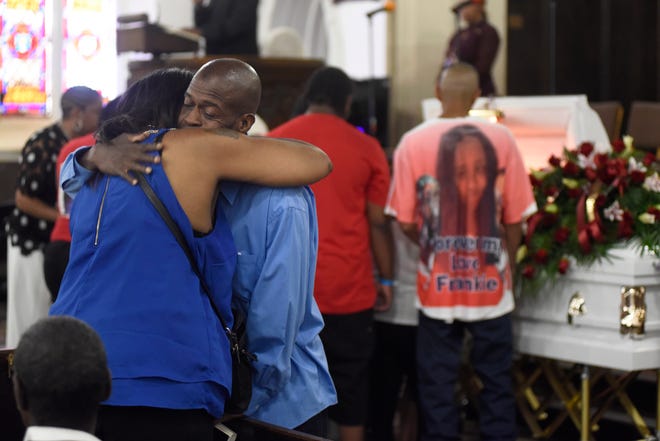 Pastor Barry Randolph hugs Sherrie Scott, the mother Francesca Marks, who died shielding her children from gunfire,  at Church of the Messiah in Detroit.