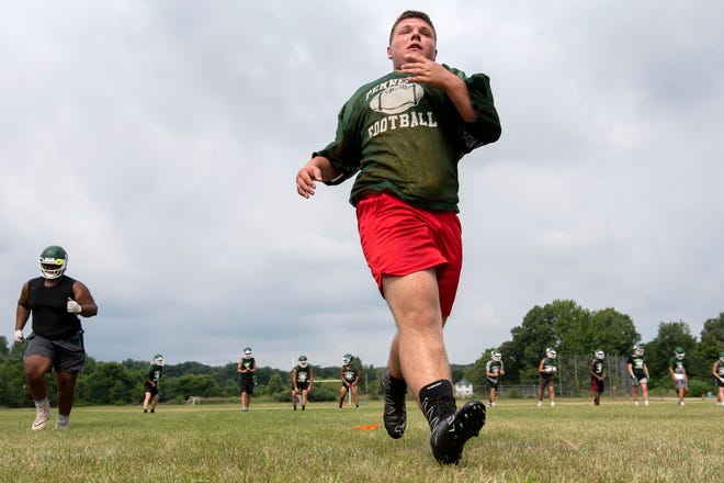 Early Monday morning, Pennfield High School football players attend their first practice of the season on Aug. 12, 2019 at Pennfield High School in Battle Creek, Mich.  