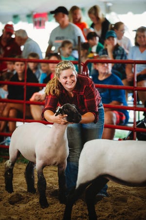 Liz Wetzel is all smiles as she leads her lamb in front of the judge in the show ring.
