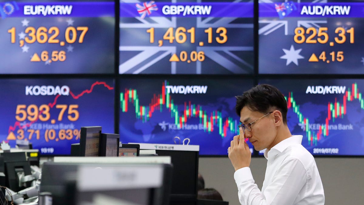 A currency trader watches monitors at the foreign exchange dealing room of the KEB Hana Bank headquarters in Seoul, South Korea, Monday, Aug. 12, 2019. Asian stocks gained Monday amid investor jitters the U.S.-China trade war might be worsening. (AP Photo/Ahn Young-joon)