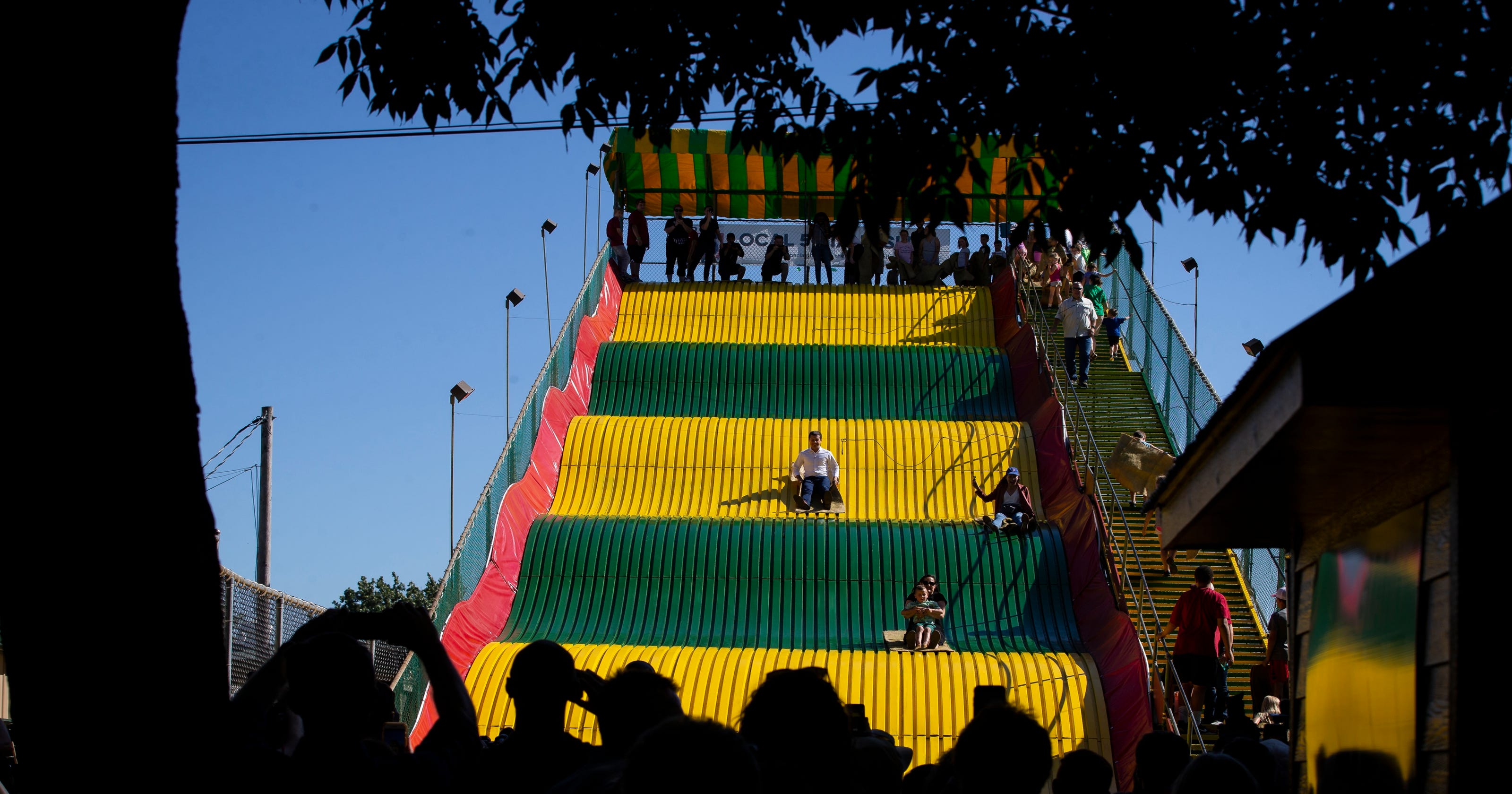 Pete Buttigieg rides the Giant Slide at the Iowa State Fair