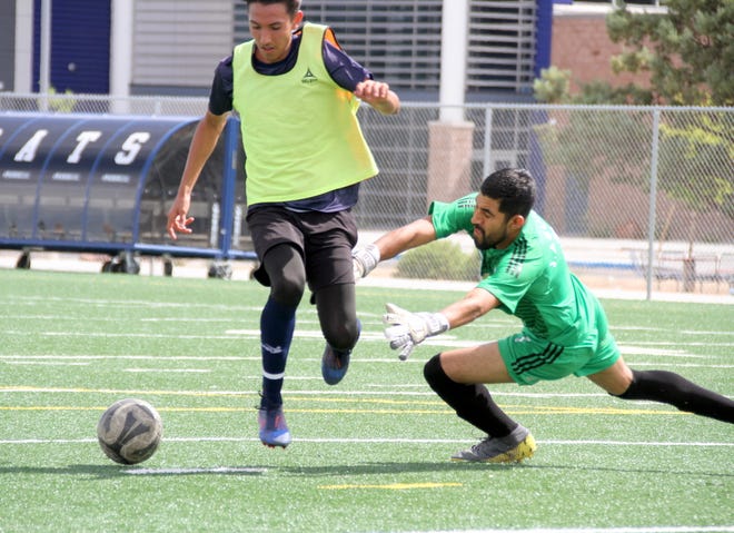 Deming Wildcat forward Cain Cisneros, left, beat the goal keeper on this breakaway to spot the Wildcats a 2-0 lead at half time of Saturday's scrimmage against the Deming Aztecas club team.