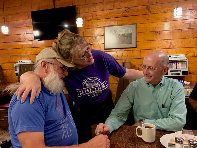 Christy Clark, who will begin her dream job as a first-year teacher Thursday, embraces one of her biggest cheerleaders, customer Larry Ferguson. Ferguson and Tom Sheriff, right, are part of a group of men who meet once a week at Pioneer of Texas on Maplewood.