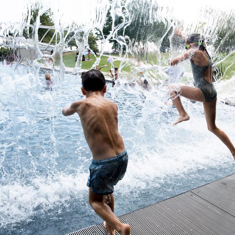 Kids cool off in water at Yards Park as...