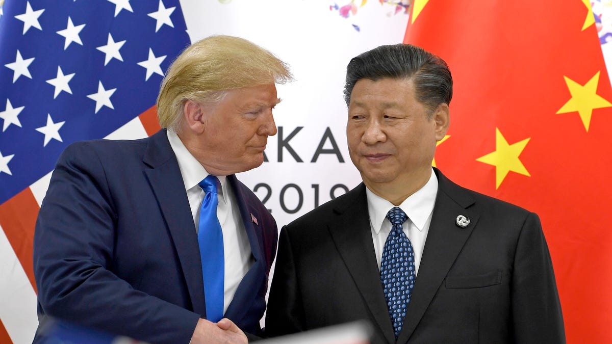 FILE - In this  June 29, 2019, file photo, U.S. President Donald Trump, left, shakes hands with Chinese President Xi Jinping during a meeting on the sidelines of the G-20 summit in Osaka, western Japan. Facing another U.S. tariff hike, Xi is getting tougher with Washington instead of backing down. Both sides have incentives to settle a trade war that is battering exporters on either side of the Pacific and threatening to tip the global economy into recession. (AP   Photo/Susan Walsh, File)