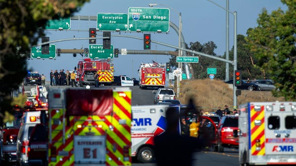 Authorities work the scene where a shootout near...