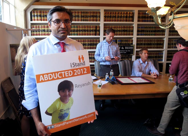 Manalapan's Ravi Parmar holds a poster showing his son Reyansh after a news conference in Red Bank Thursday, August 8, 2019. His son Reyansh was taken by his mother to India.