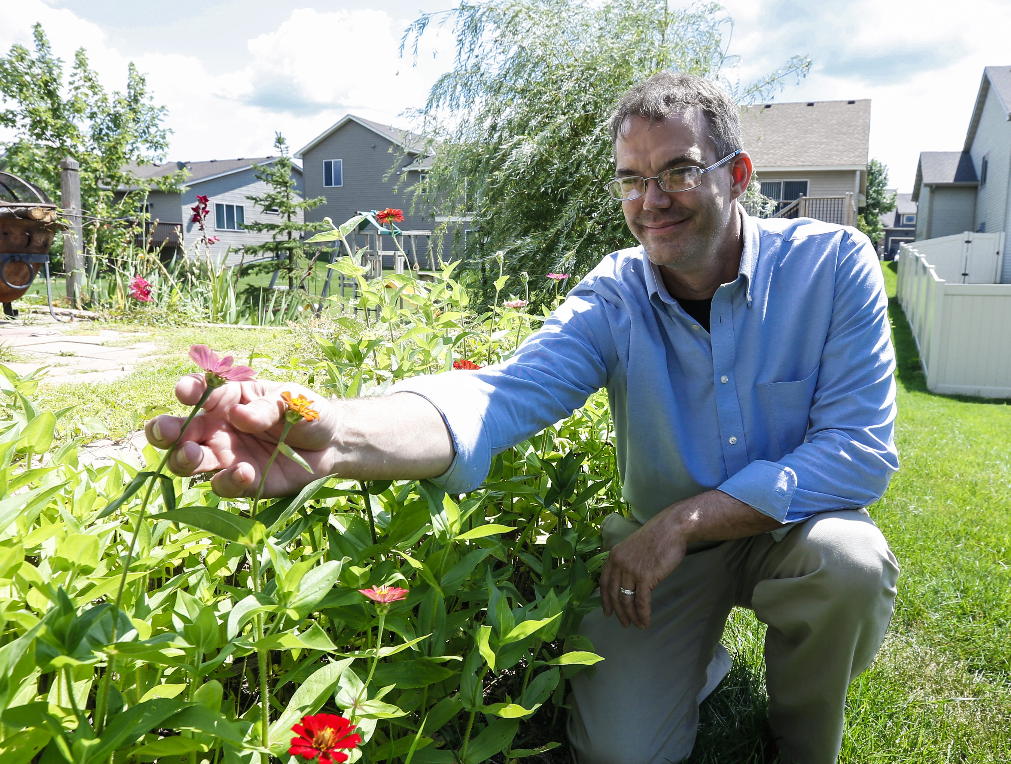 Nate Lindstrom works on his garden in August 2019 at his house in Ramsey, Minn.