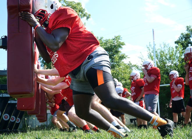   Canton linemen hit the sled during an Aug. 14 practice.                             