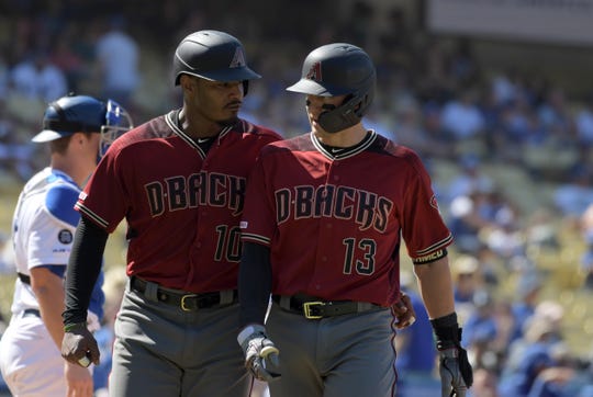 Aug 11, 2019: Arizona Diamondbacks shortstop Nick Ahmed (13) celebrates with right fielder Adam Jones (10) after hitting a two-run home run in the ninth inning against the Los Angeles Dodgers  at Dodger Stadium. The Dodgers defeated the Diamondbacks 9-3.