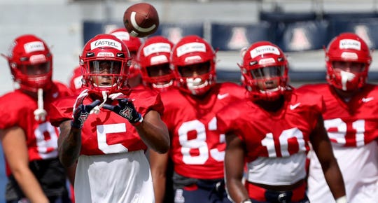UA wide receiver Brian Casteel takes a throw as the receivers run through their drills during a practice last week. The Wildcats open their season Aug. 24.