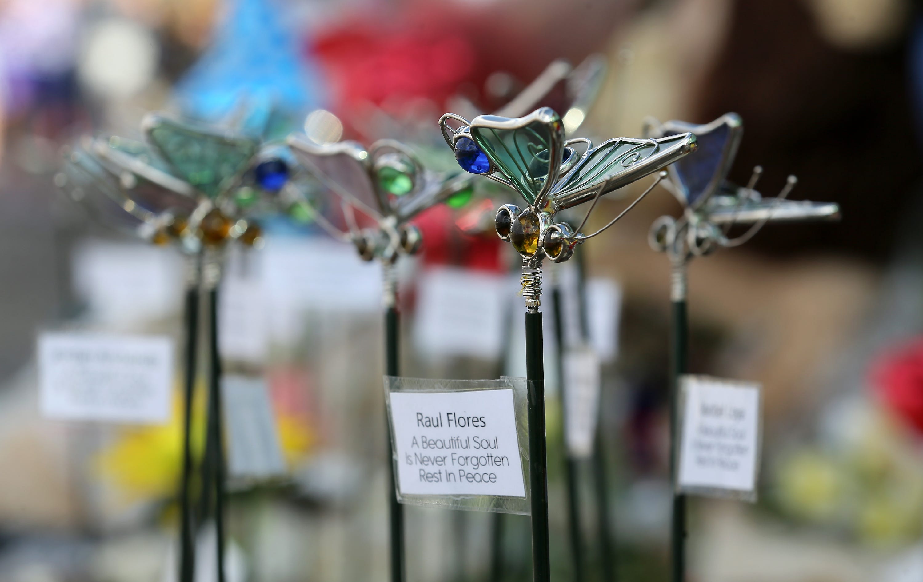 Twenty two glass butterfly garden stakes represent those killed in the attack at Walmart on August, 3. Each has the name of a victim attached to the stick. 