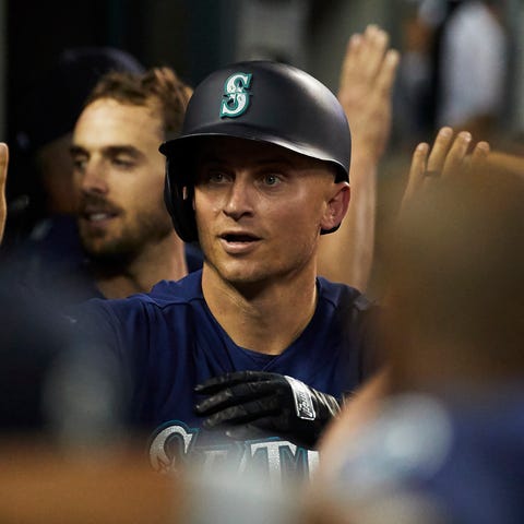 Kyle Seager is congratulated by teammates after a...