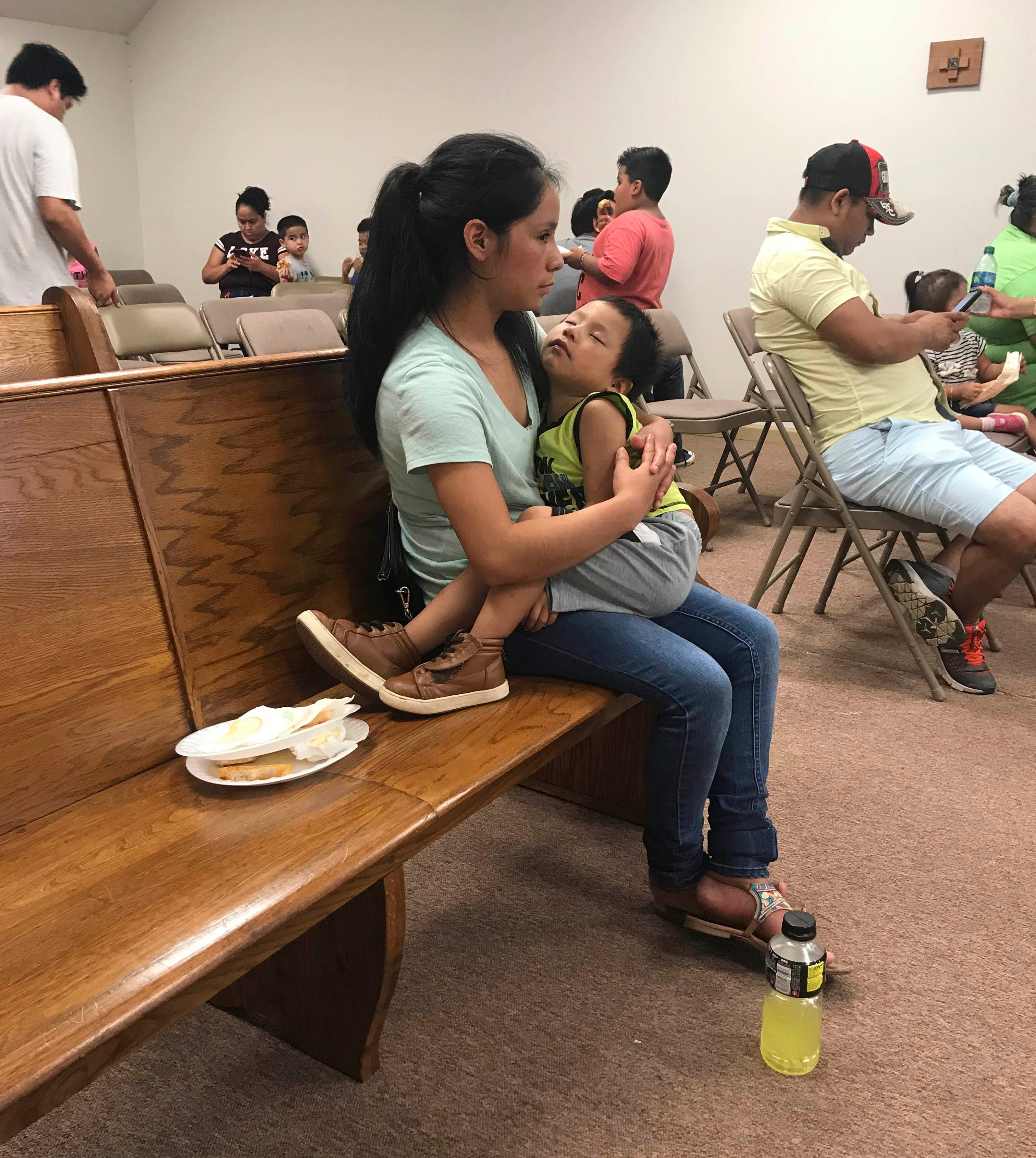 Workers from PH Foods and their supporters wait to speak to lawyers at St. Martin de Porres Catholic Church on Aug. 13, 2019, in Morton, Miss., days after federal agents arrested 99 people there for immigration violations.