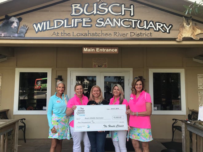Amy Kight, center, executive director of Busch Wildlife Sanctuary, accepts a $5,000 donation from CouTOURe Club members Damiann Hendel, left, Deborah Jaffe, Ashley Schulties and Karen List. The CouTOURe Club is a volunteer organization of women dedicated to increasing awareness of The Honda Classic and its mission to raise money for children's charities.