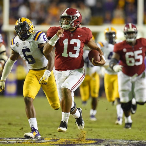 Alabama quarterback Tua Tagovailoa carries for a 4