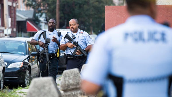 Police officers patrol during an active shooting...