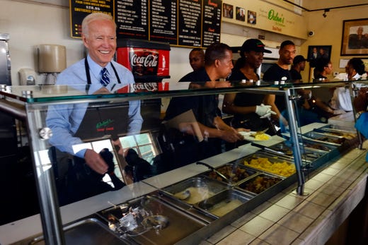 Democratic presidential candidate former Vice President Joe Biden serves breakfast during a visit to Dulan's Soul Food on Crenshaw on July 18, 2019 in Los Angeles. 