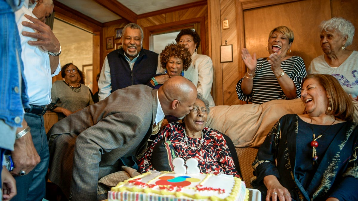 Vincent Tucker plants a kiss on Carol Tucker Jones during her 88th birthday celebration in Hampton, Va. on Sunday, March 31, 2019. 