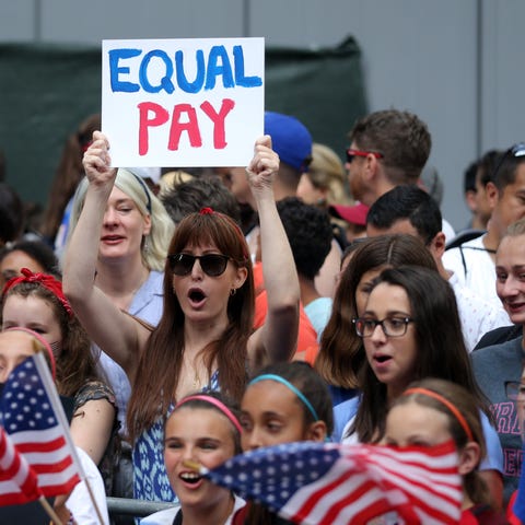 Fans in Manhattan chant for equal pay as they...