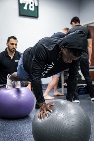 New Orleans Saints running back Alvin Kamara trains with Dr. Sharif Tabbah (rear, in black shirt) at Athletix Rehab and Recovery.