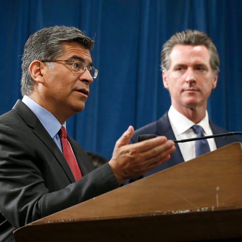 California Attorney General Xavier Becerra, left, 