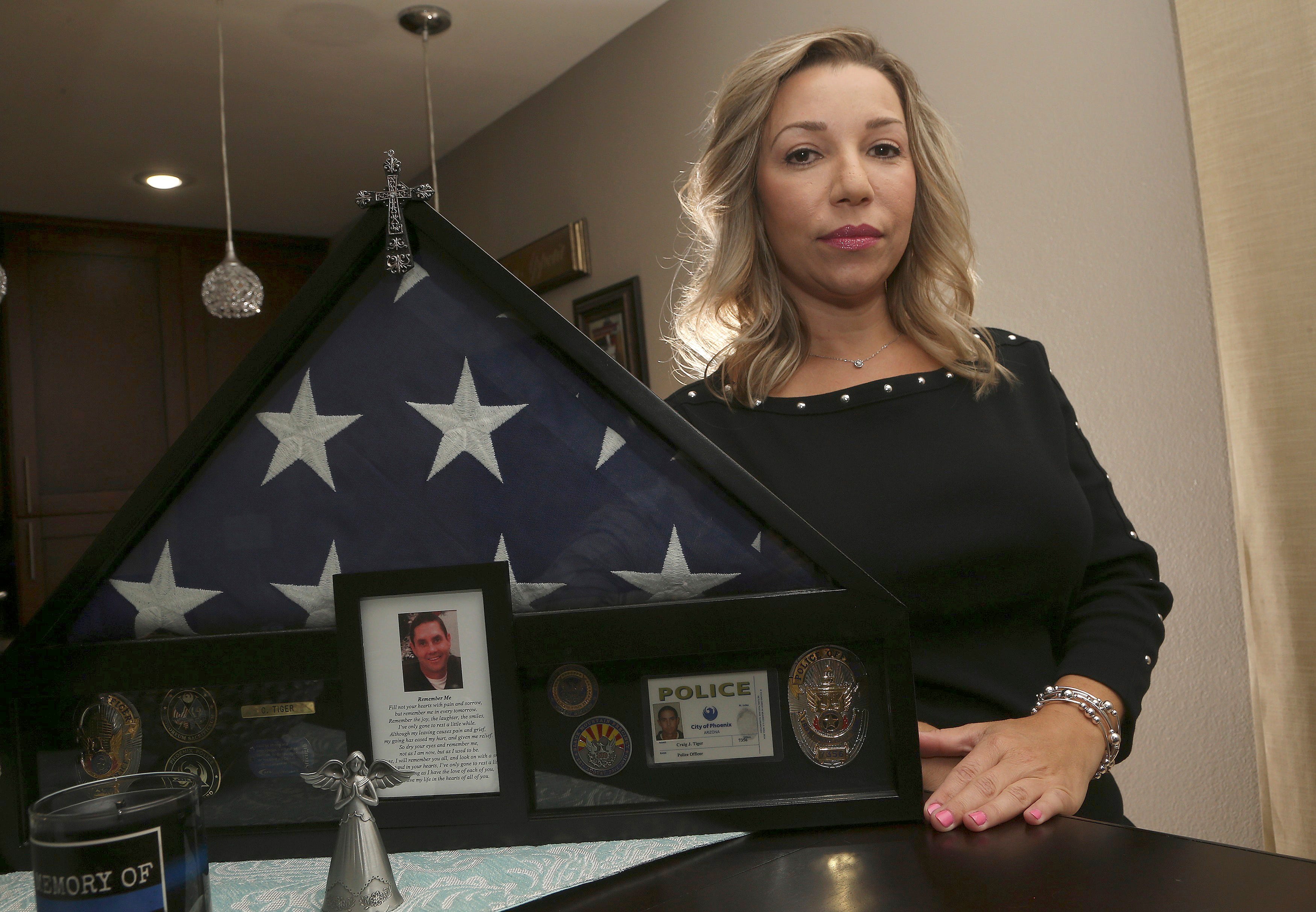 Rebecca Tiger, a former Phoenix police officer, is the ex-wife of Craig Tiger, a Phoenix police officer who took his own life a few years ago following a fatal shooting he was involved in, shown her home Monday, July 1, 2019, in Scottsdale, Ariz. Officer Craig Tiger suffered from post-traumatic stress disorder after fatally shooting a man while on duty back in 2012, and took his own life two years later.