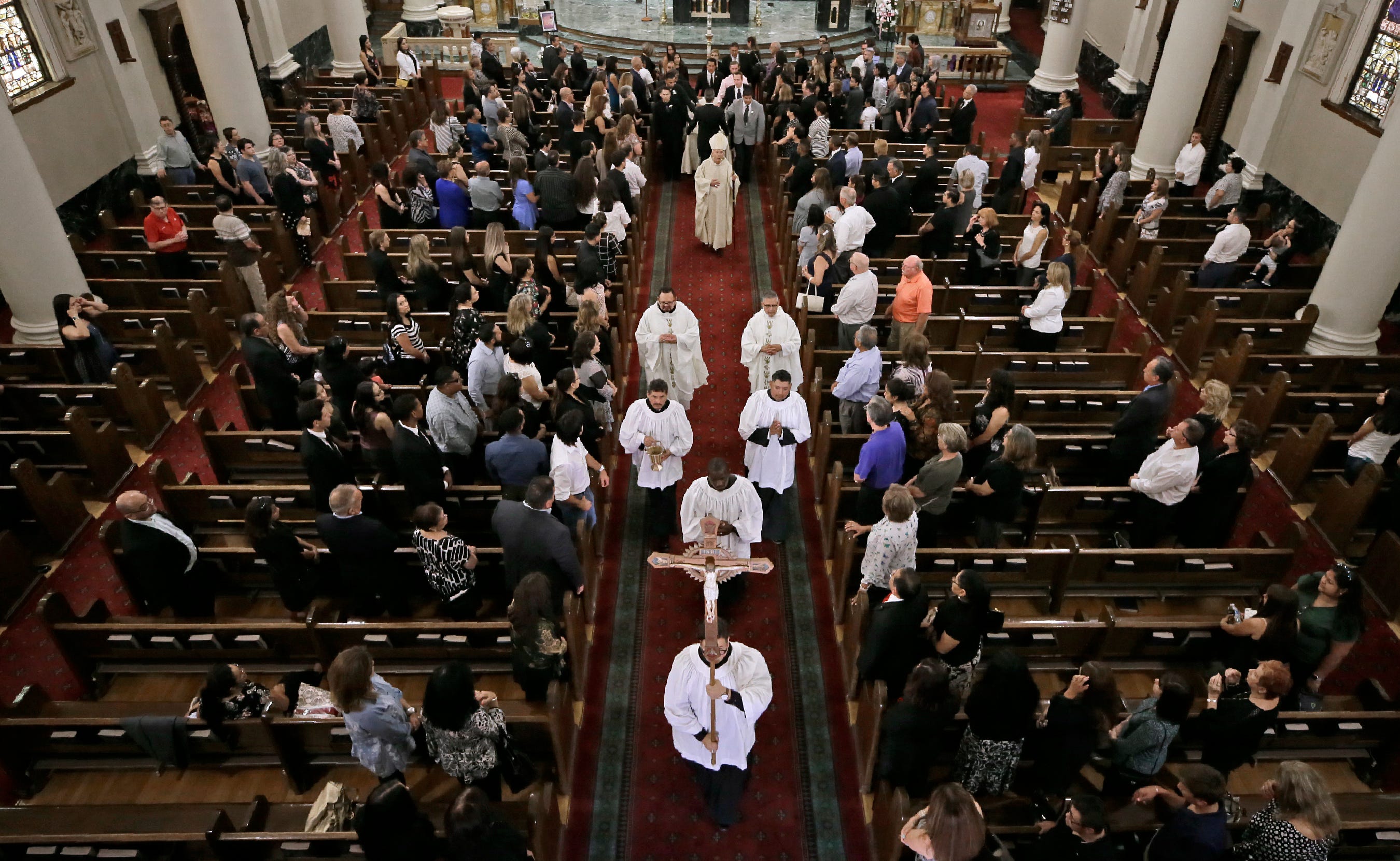 Family and friends of Andre Anchondo prepare to leave St. Patrick Cathedral in El Paso, Texas, following the funeral Mass for the father, who was killed in a racism-fueled attack at Walmart on Aug. 3, 2019.