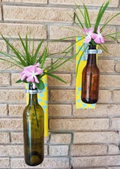 The ring should be attatched securely, but the bottle should be able to swing freely. Now, hang it where you would like it, fill with water and place your favorite flowers in it.