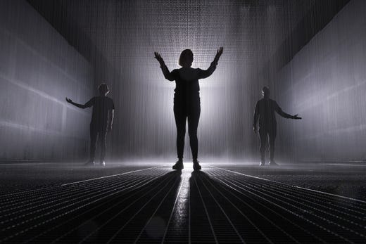 Art installation 'Rain Room' by Random International is seen in the Jackalope Pavilion on August 08, 2019 in Melbourne, Australia. The installation is a 100 square meter field of continuous rainfall, and is a responsive environment engaging all the senses; millions of water droplets respond to your presence by ceasing to fall wherever movement is detected, allowing you to be fully immersed in the rain while simultaneously protected from it.