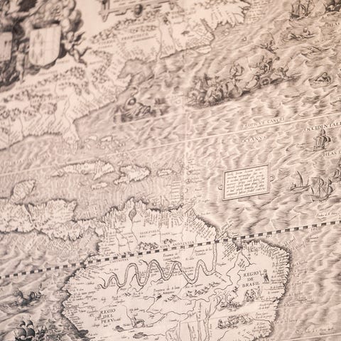 A map depicting the Transatlantic Slave Trade sits