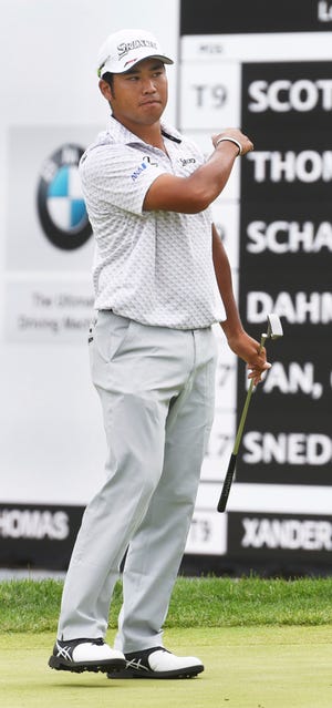 Hideki Matsuyama celebrates after putting for a birdie on the 18th during action Friday at the BMW Championship golf tournament at Medinah, Ill.