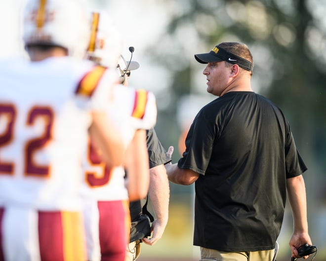 Gibson Southern's Head Coach Nick Hart, right, talks to his team during a pre-season scrimmage against the Central Bears at Central Stadium in Evansville, Ind., Friday, Aug. 16, 2019.