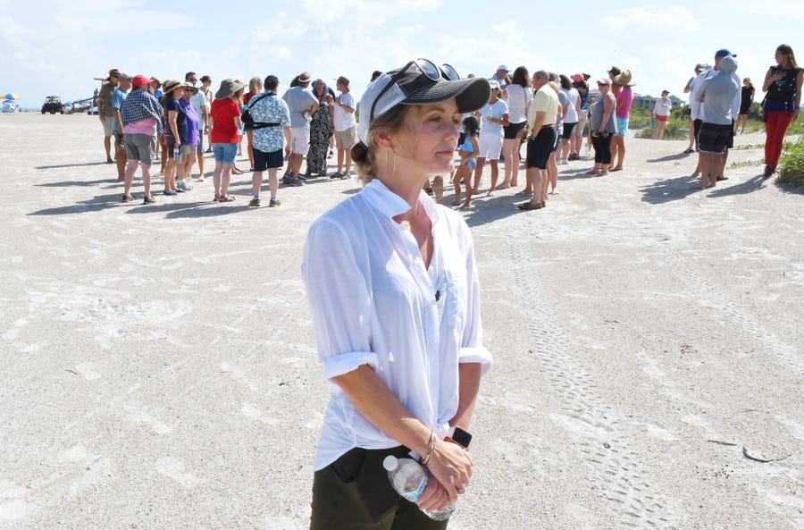 Stephanie Young McCluney, wife of Brian McCluney, one of two missing boaters, is joined by supporters who gathered at Jetty Park Aug. 18 to pray and search the shore for any clues in the search for the missing boaters who left Port Canaveral.