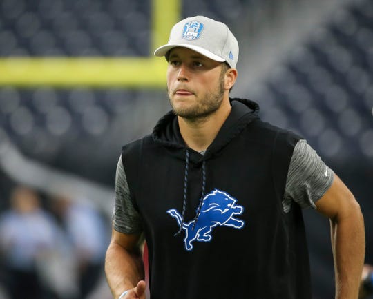 Detroit Lions quarterback Matthew Stafford jogs on the field before a game against the Houston Texans at NRG Stadium on August 17, 2019 in Houston.