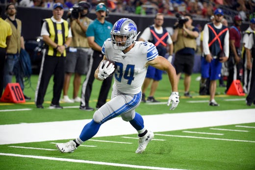 Detroit Lions running back Zach Zenner (34) scores a touchdown after catching a pass against the Houston Texans during the second half.