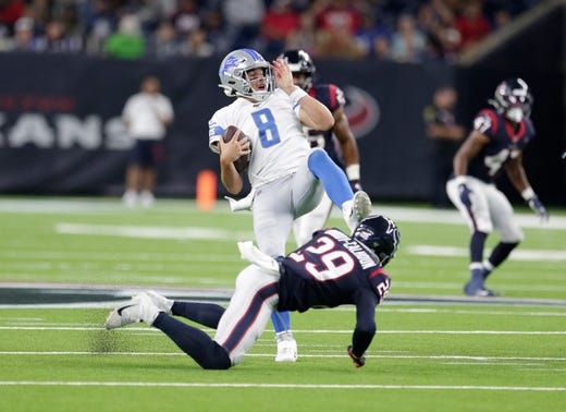 Detroit Lions quarterback David Fales (8) is tripped up by Houston Texans cornerback Briean Boddy-Calhoun (29) during the second half.